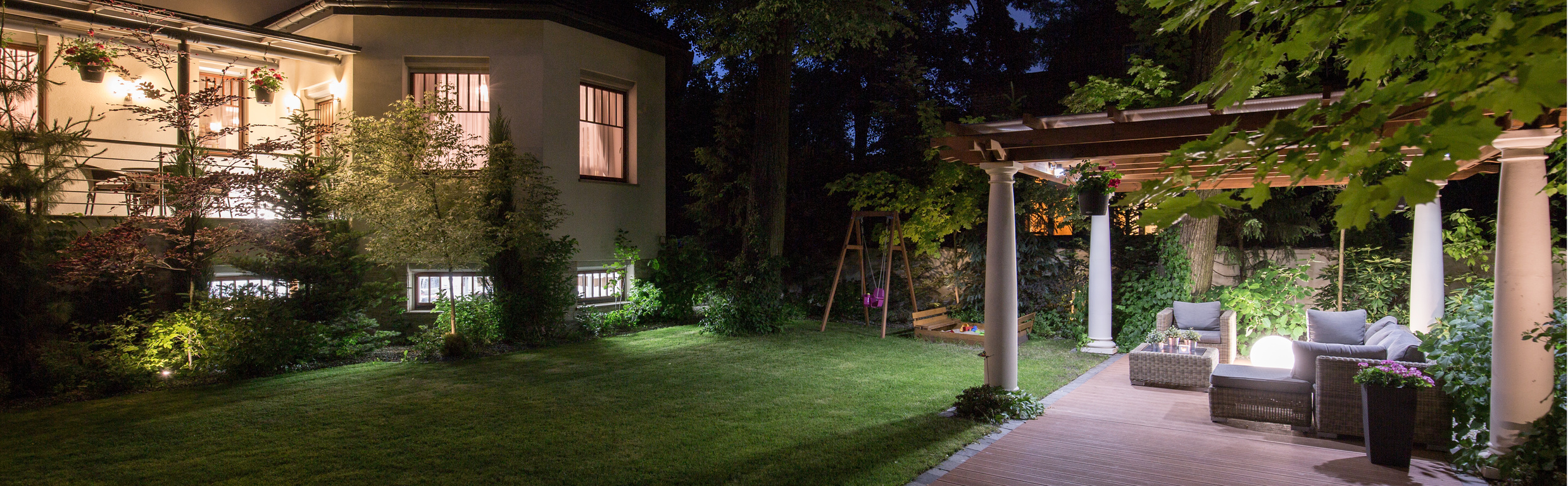 Luxury villa with patio in garden at night